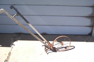 Vintage iron age hand garden wheel cultivator