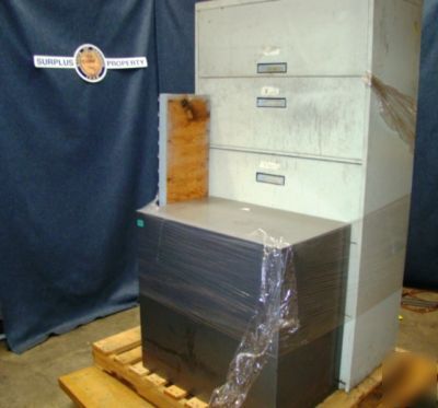Lot of file cabinets and a wall rack