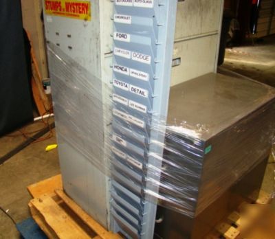 Lot of file cabinets and a wall rack