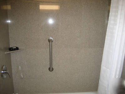 Solid granite bath surrounds--speckled grey