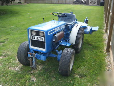 Ford 1100 diesel tractor 4X4 w/rear mower deck & plow.
