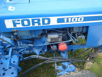 Ford 1100 diesel tractor 4X4 w/rear mower deck & plow.