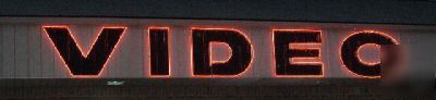 Large video neon sign outside wall mounted giant letter
